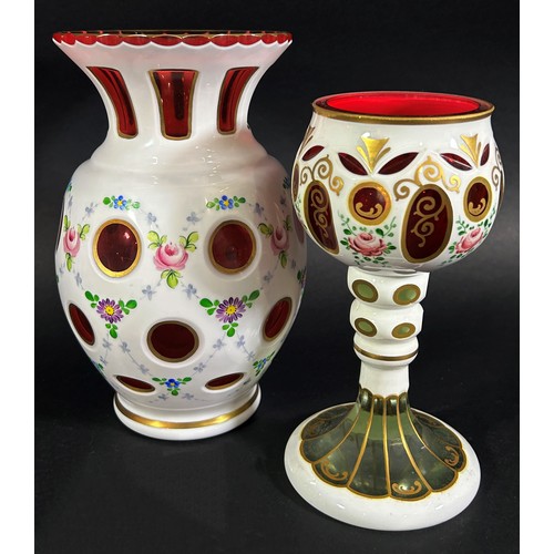 147 - A varied collection of Bohemian and Cranberry glassware, including a Bohemian glass overlay vase and... 