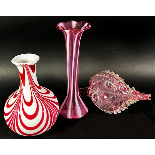 148 - A collection of 19th century Nailsea glassware, including a pink candy stripe bellows, two flats bot... 