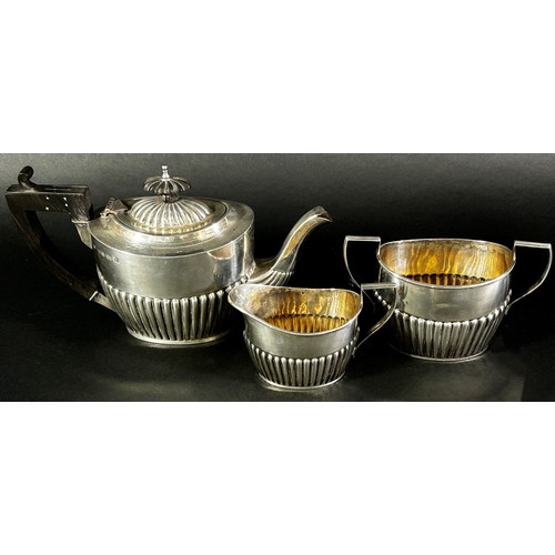 213 - A three piece silver tea set, Birmingham 1900 maker Henry Willliamson Ltd, and a weighted silver vas... 