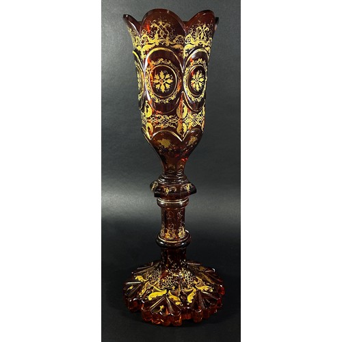 151 - A 19th century tall Bohemian Gothic amber decorated glass vase, with a curved crenellated rim raised... 