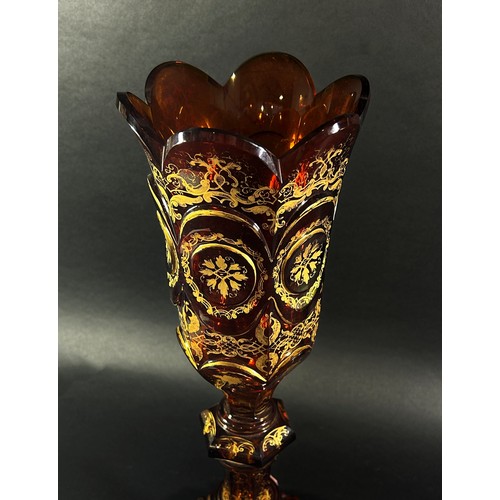 151 - A 19th century tall Bohemian Gothic amber decorated glass vase, with a curved crenellated rim raised... 