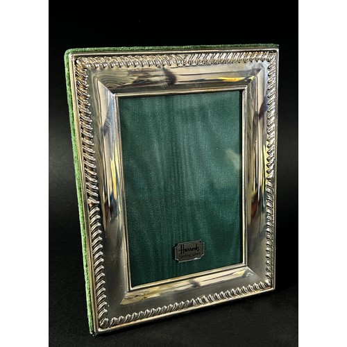 222 - Three Harrods sterling silver rectangular photo frames with Harrods green silk backing, together wit... 