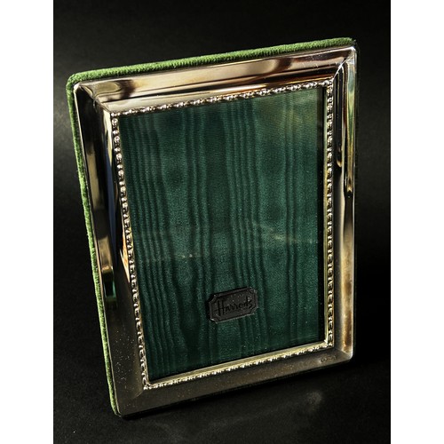 222 - Three Harrods sterling silver rectangular photo frames with Harrods green silk backing, together wit... 