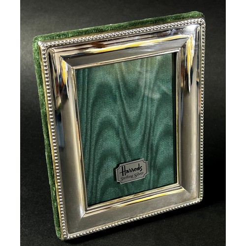 222 - Three Harrods sterling silver rectangular photo frames with Harrods green silk backing, together wit... 