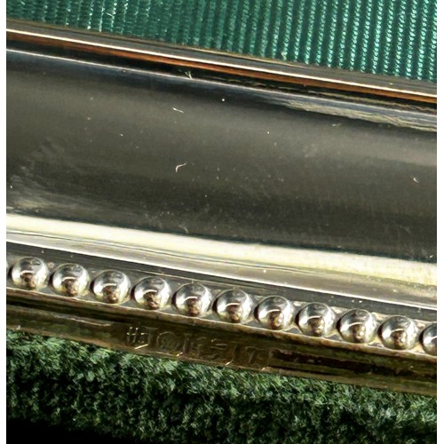 222 - Three Harrods sterling silver rectangular photo frames with Harrods green silk backing, together wit... 