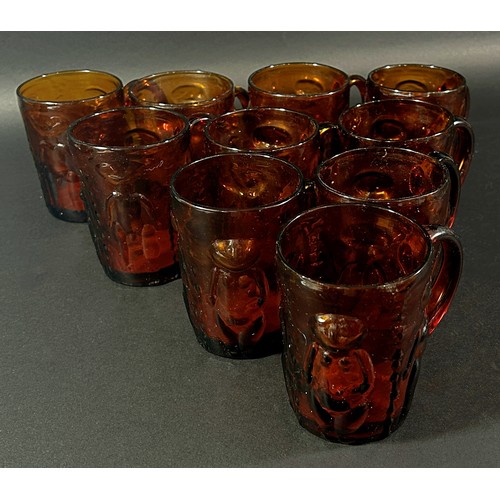 154 - Ten Erik Hoglund amber coloured drinking glasses, decorated with naked people, some with original st... 