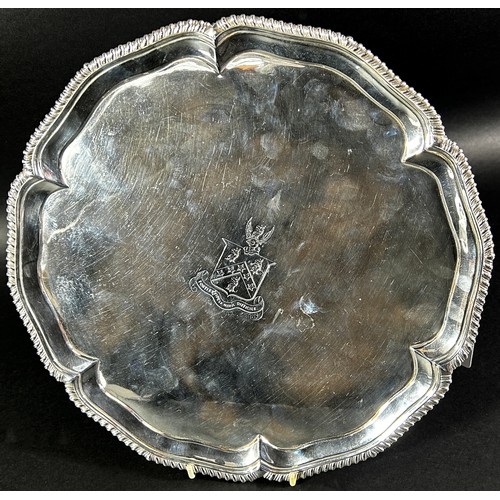 240 - A George III silver salver with a gadrooned edge raised on pad feet, London 1770, maker Ebenezer Cok... 