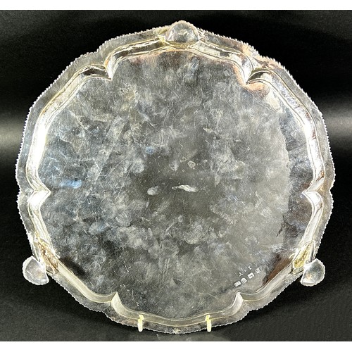 240 - A George III silver salver with a gadrooned edge raised on pad feet, London 1770, maker Ebenezer Cok... 