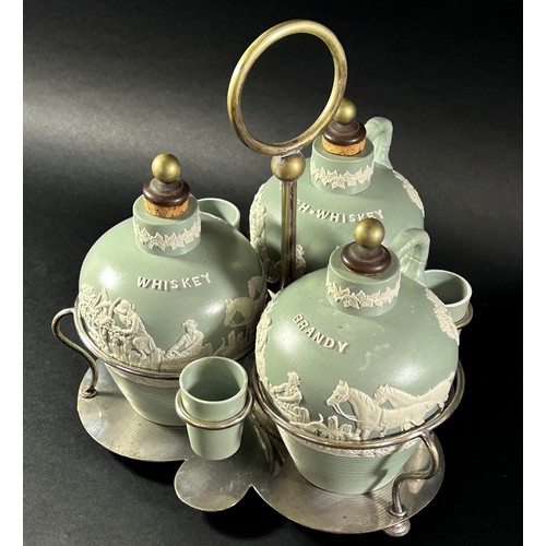 78 - A late 19th century three bottle tantalus ceramics and silver plate frame, supporting three ceramic ... 