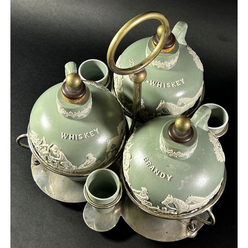 78 - A late 19th century three bottle tantalus ceramics and silver plate frame, supporting three ceramic ... 