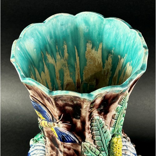 79 - A late 19th century majolica vase, the fluted neck set within a circular ring encrusted with lizards... 