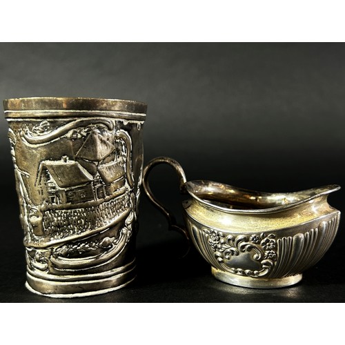 190 - A small silver cream jug, a silver bird claw sugar tong and a Dutch? beaker with a dairy farm scene,... 