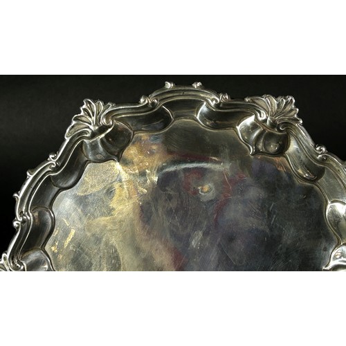 184 - A small George II silver salver with ogee scroll and shell rim, raised on three pad feet, London 175... 