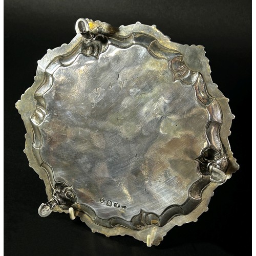 184 - A small George II silver salver with ogee scroll and shell rim, raised on three pad feet, London 175... 