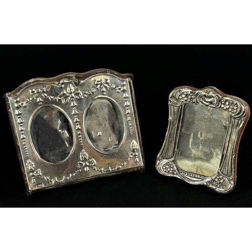 218 - A small silver photo frame with double oval openings with swag and flower decoration, 9 x 8 cm overa... 