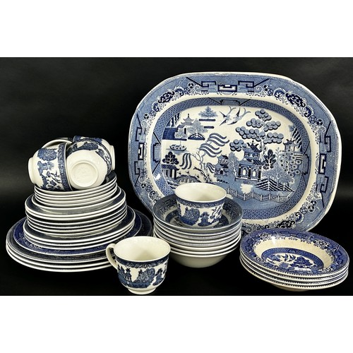 93 - A collection of blue and white china including Willow pattern and meat plates, cups saucers, plates,... 