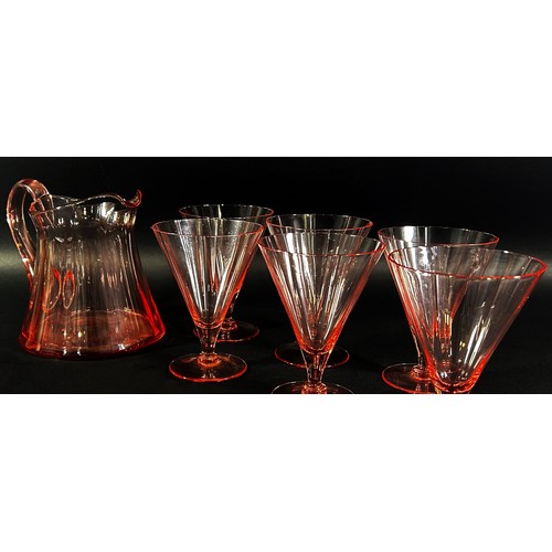 140 - An Art Deco pink glass drinks set, with a single jug and six conical glasses.