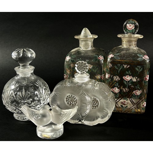 139 - A Lalique glass Deux Fleurs Scent bottle, and a Lalique glass Kissing Doves paperweight (chip to tai... 