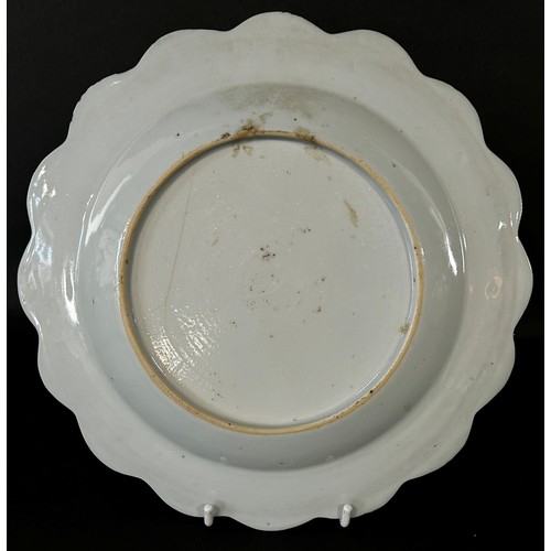 55 - A Chinese blue and white export plate with scalloped edge with pagoda, landscape and floral detail