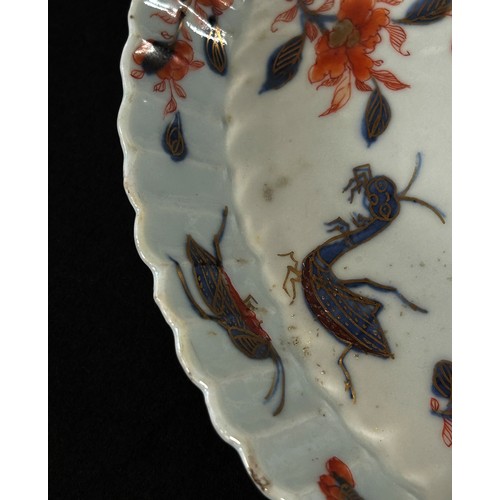 54 - An 18th century Chinese Kangxi Imari plate decorated with flowers and insects, the dish of oval form... 