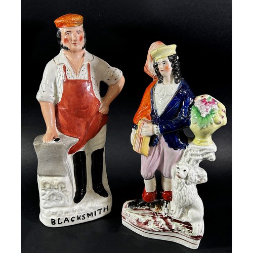 71 - A collection of figurines including a 19th century Staffordshire flatback group - The Blacksmith, fu... 