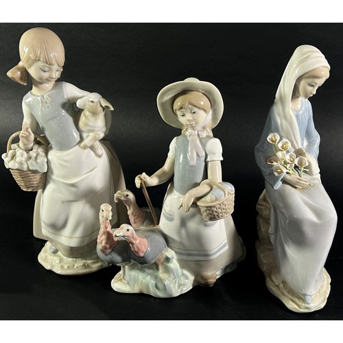 105 - Three Lladro figures, one of a girl shepherding Turkey's, another holding a Lamb, a third with a bou... 