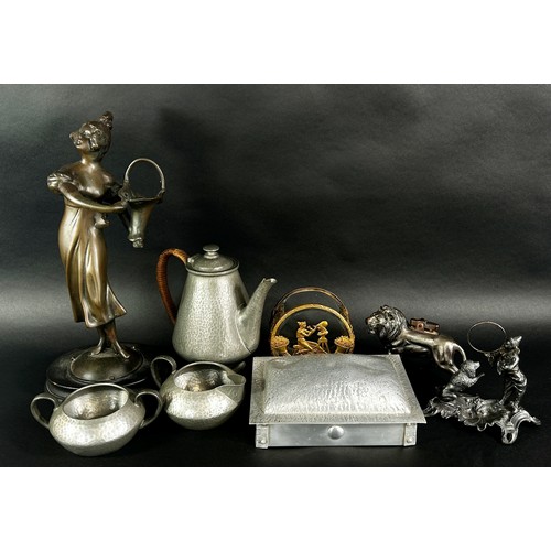 266 - A Tudric Pewter three piece tea service, a muffin dish, a bronzed lion table lighter, a performing c... 