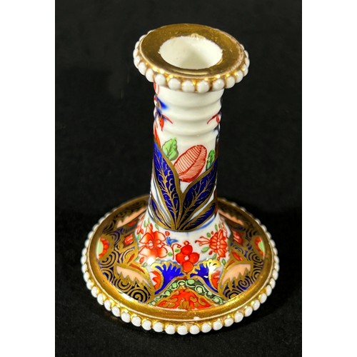 409 - An early 19th century miniature Spode taper stick with beaded rims, richly decorated with Imari deta... 