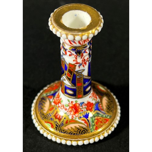 409 - An early 19th century miniature Spode taper stick with beaded rims, richly decorated with Imari deta... 