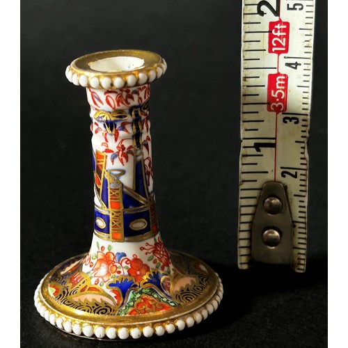 409 - An early 19th century miniature Spode taper stick with beaded rims, richly decorated with Imari deta... 