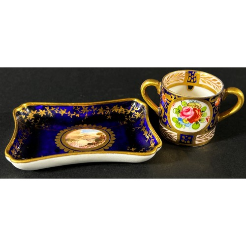 414 - A miniature Coalport pin tray with dark blue ground and central landscape panel, 7cm long, with rece... 