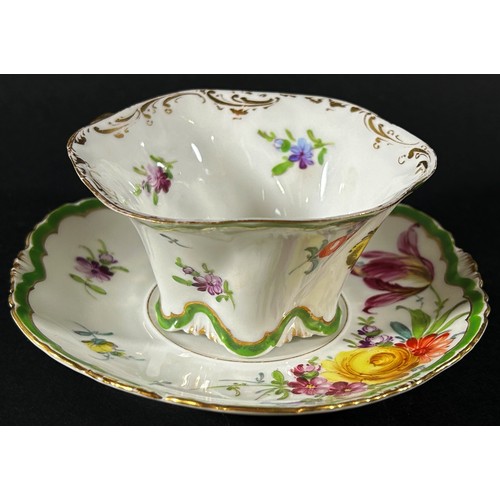 419 - A Dresden cabinet cup and saucer with hand painted floral sprays within green and gilt bands