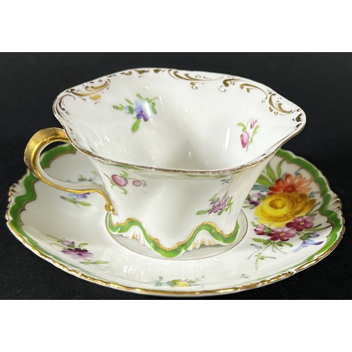 419 - A Dresden cabinet cup and saucer with hand painted floral sprays within green and gilt bands