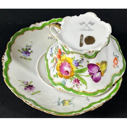 419 - A Dresden cabinet cup and saucer with hand painted floral sprays within green and gilt bands