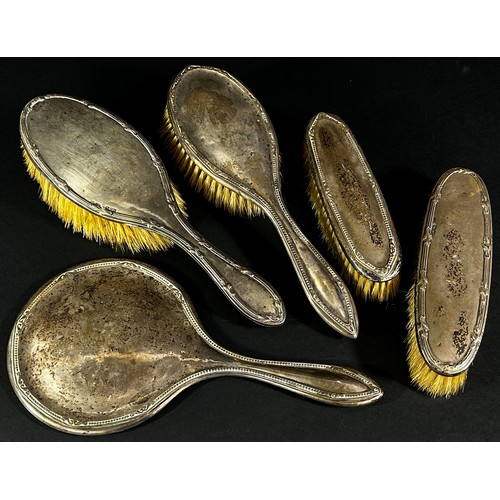 219A - Four silver backed brushes and a single silver backed hand mirror (5)