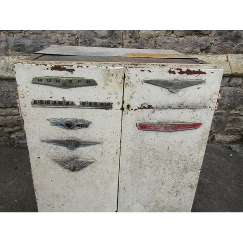 1025 - A vintage heavy gauge industrial painted steel two door cabinet with applied car badges 72 cm high x... 