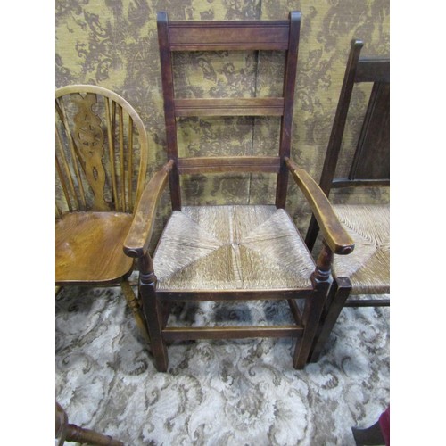 1075 - A set of four (3&1) Windsor stained beechwood wheelback dining chairs together with two rush seated ... 