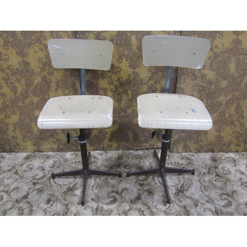 1079 - A pair of vintage swivel machinist/typist chairs with moulded plywood seats and backs