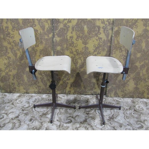 1079 - A pair of vintage swivel machinist/typist chairs with moulded plywood seats and backs