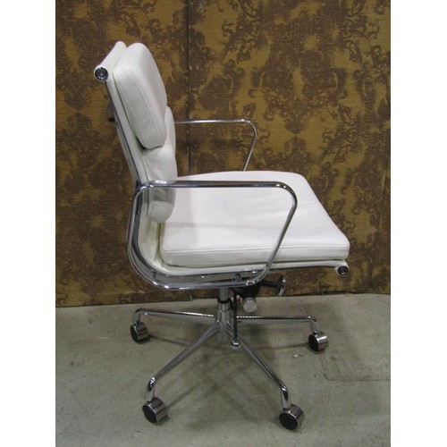 1080 - A contemporary chrome framed office chair with swivel base, upholstered in a faux white leather fini... 