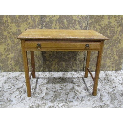 1086 - An Arts & Crafts oak side table with shallow frieze drawer raised on square cut and moulded supports... 