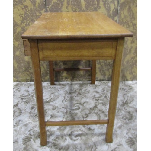 1086 - An Arts & Crafts oak side table with shallow frieze drawer raised on square cut and moulded supports... 