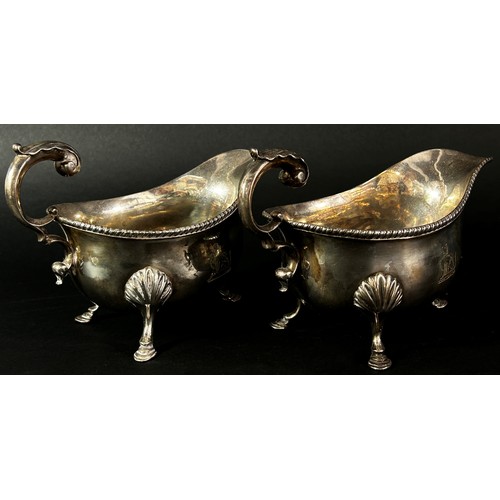 236 - A pair of early 19th century silver gravy boats with acanthus scrolled handle, hallmarks rubbed, 14.... 