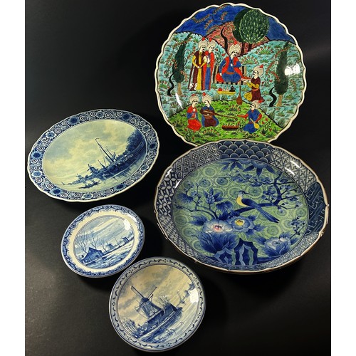 109 - Four Delft plates, a Persian plate showing musicians upon a terrace, (5)