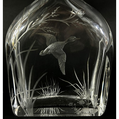 131 - A cut glass Swedish Orrefors decanter with a flying duck amongst river plants, the initials RA engra... 