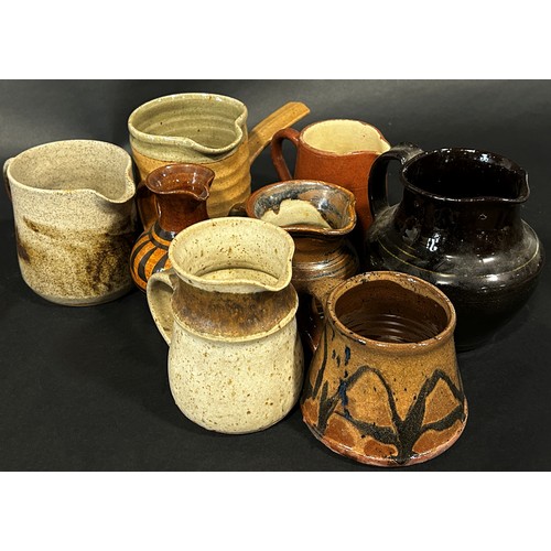 14 - A collection of studio pottery ware to include mug and jugs by Ronald Jones of Winchcombe Pottery Br... 