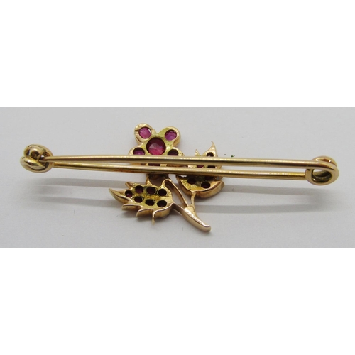 314 - Yellow metal bar brooch set with a floral cluster of rubies, 4.2cm W approx, 3.1g, contained in a po... 