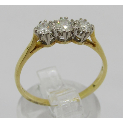 326 - 18ct three stone diamond ring, centre stone 0.20ct approx, outer stones 0.15ct each approx, London 2... 