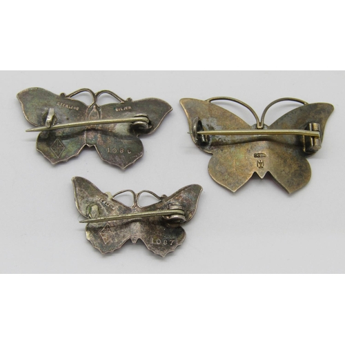 342 - Three enamelled silver butterfly brooches; a pink 830S example by Marius Hammer, a cobalt blue examp... 