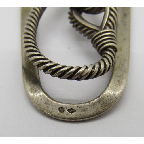 351 - Small group of silver comprising a Hermes rope design money clip, a hinged bangle with engraved scro... 